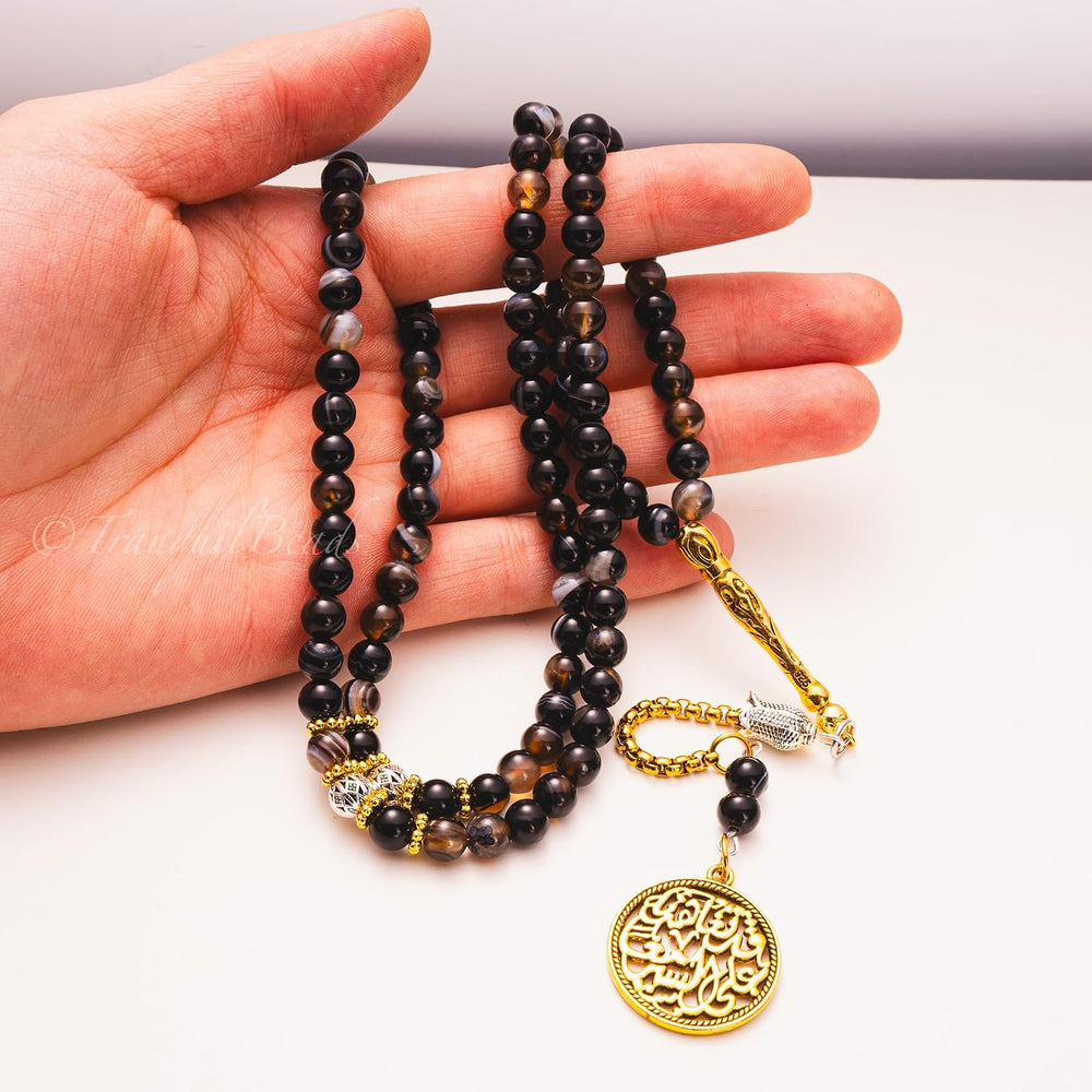 Agate tasbih held in hand