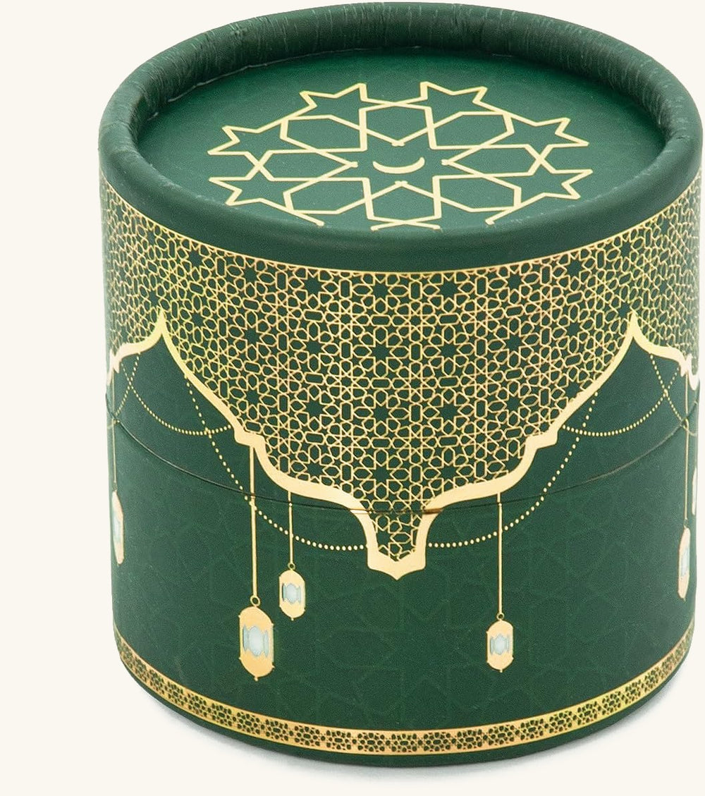 Closed dark green cylinder gift box with gold Islamic lantern pattern and star medallion lid