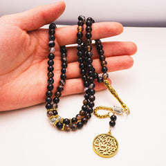 Agate tasbih held in hand